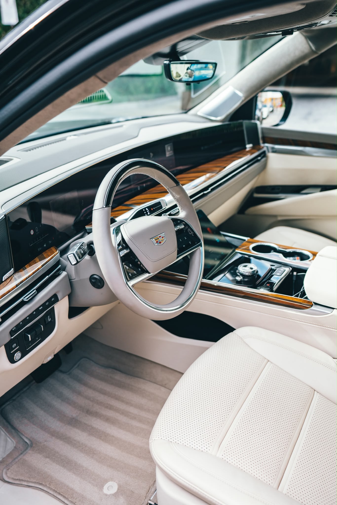 Cadillac Escalade interior with cream leather seats and wood trim