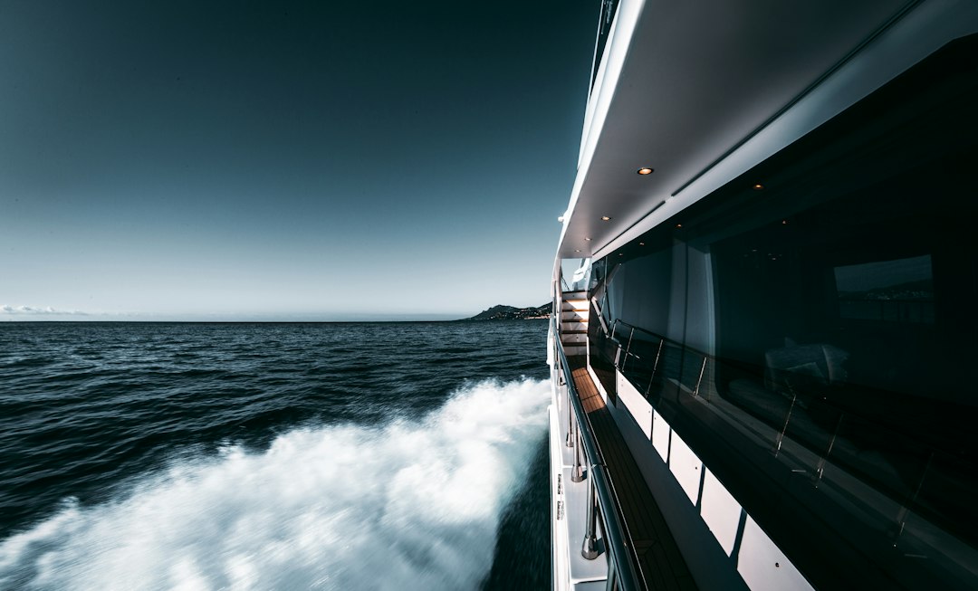 View along the side deck of a motor yacht cruising at sea